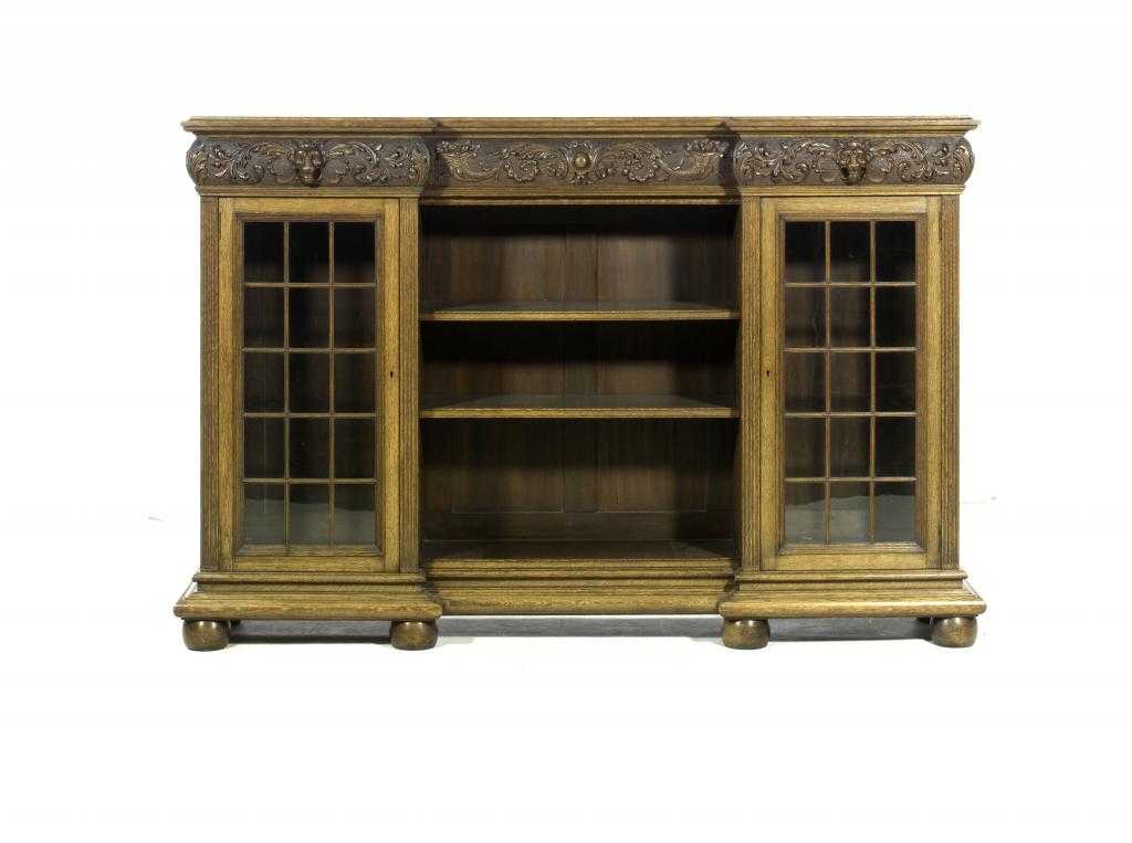 Appraisal: A CARVED OAK BOOKCASE of inverted breakfront design with three