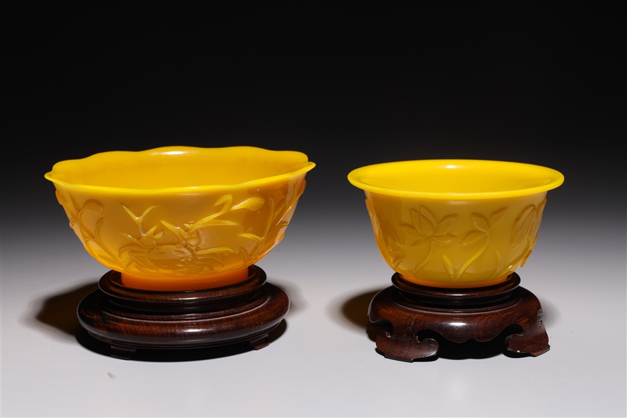 Appraisal: Two Chinese yellow Peking glass bowls each with wood stand