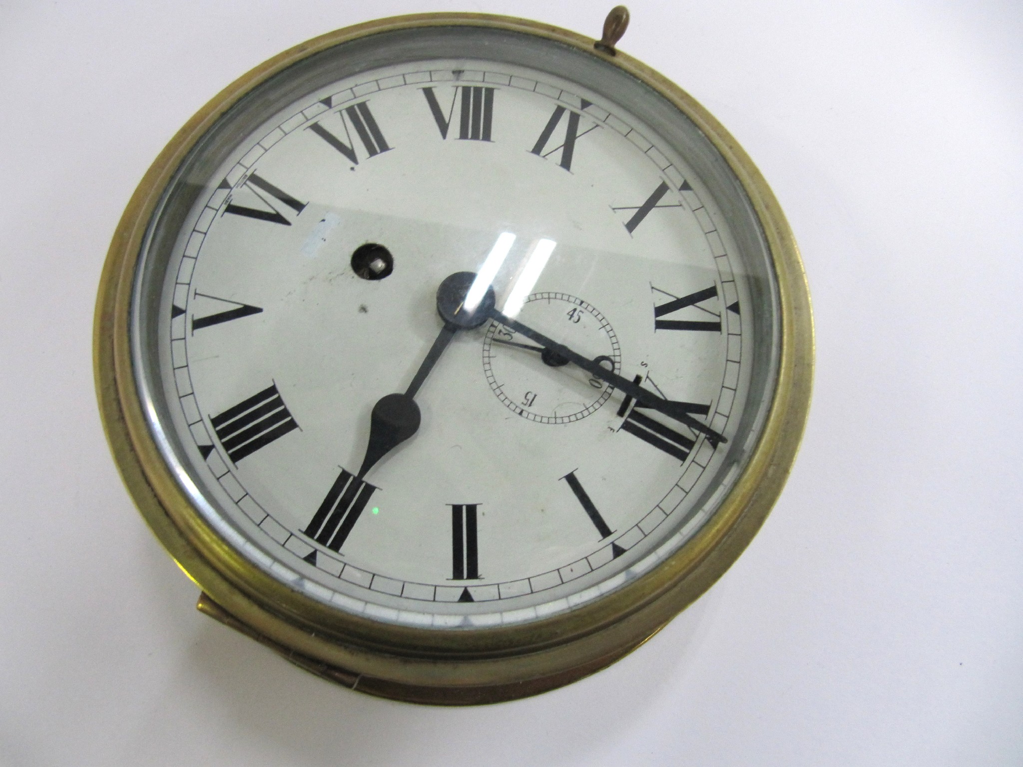 Appraisal: A bulkhead clock in brass case