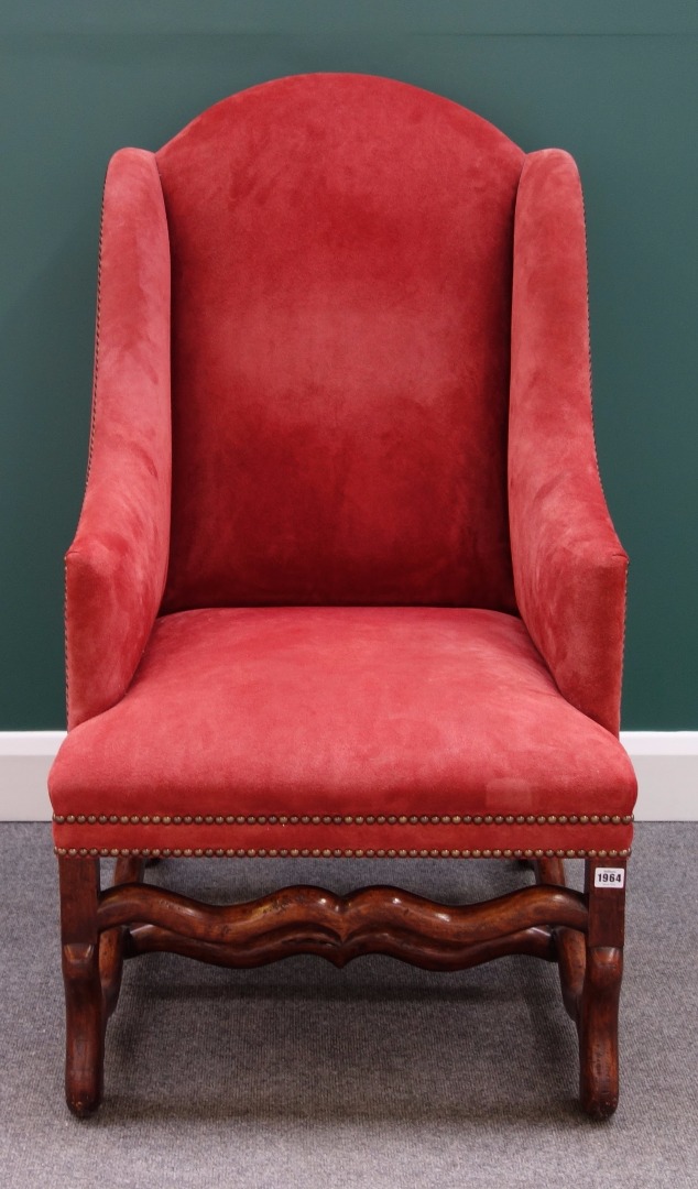 Appraisal: A walnut framed wingback easy armchair with downswept arms and