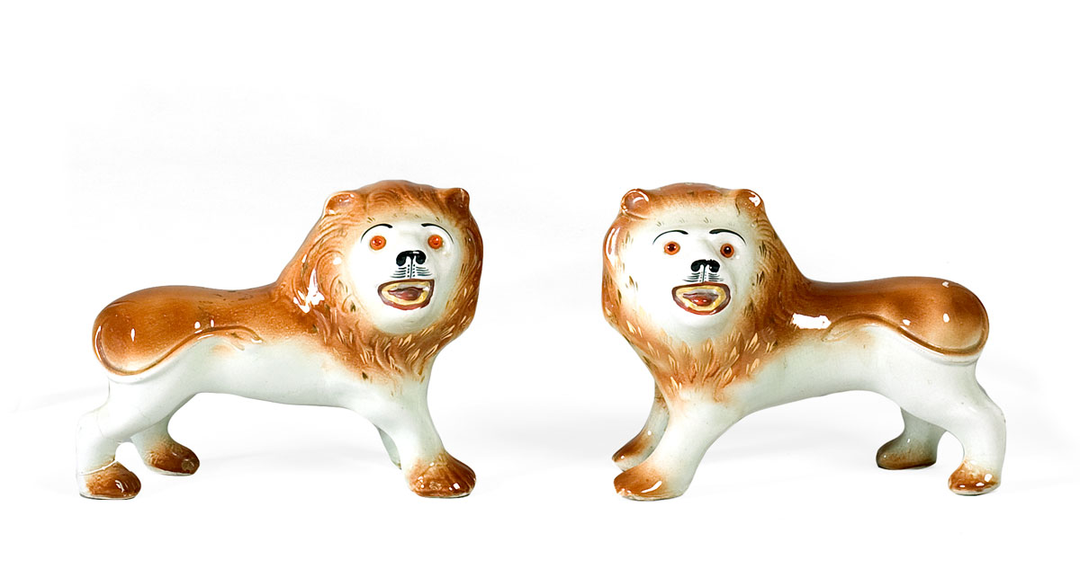 Appraisal: PAIR OF STAFFORDSHIRE FIGURES OF LIONS EACH WITH GLASS EYES