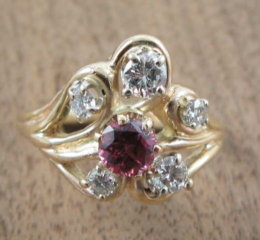 Appraisal: PINK SAPPHIRE AND DIAMOND RING the k yellow gold band