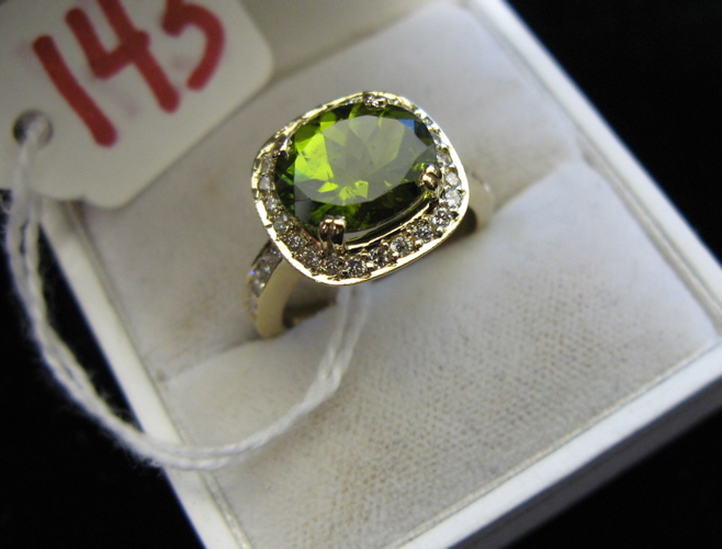 Appraisal: PERIDOT DIAMOND AND FOURTEEN KARAT GOLD RING round-cut diamonds surround