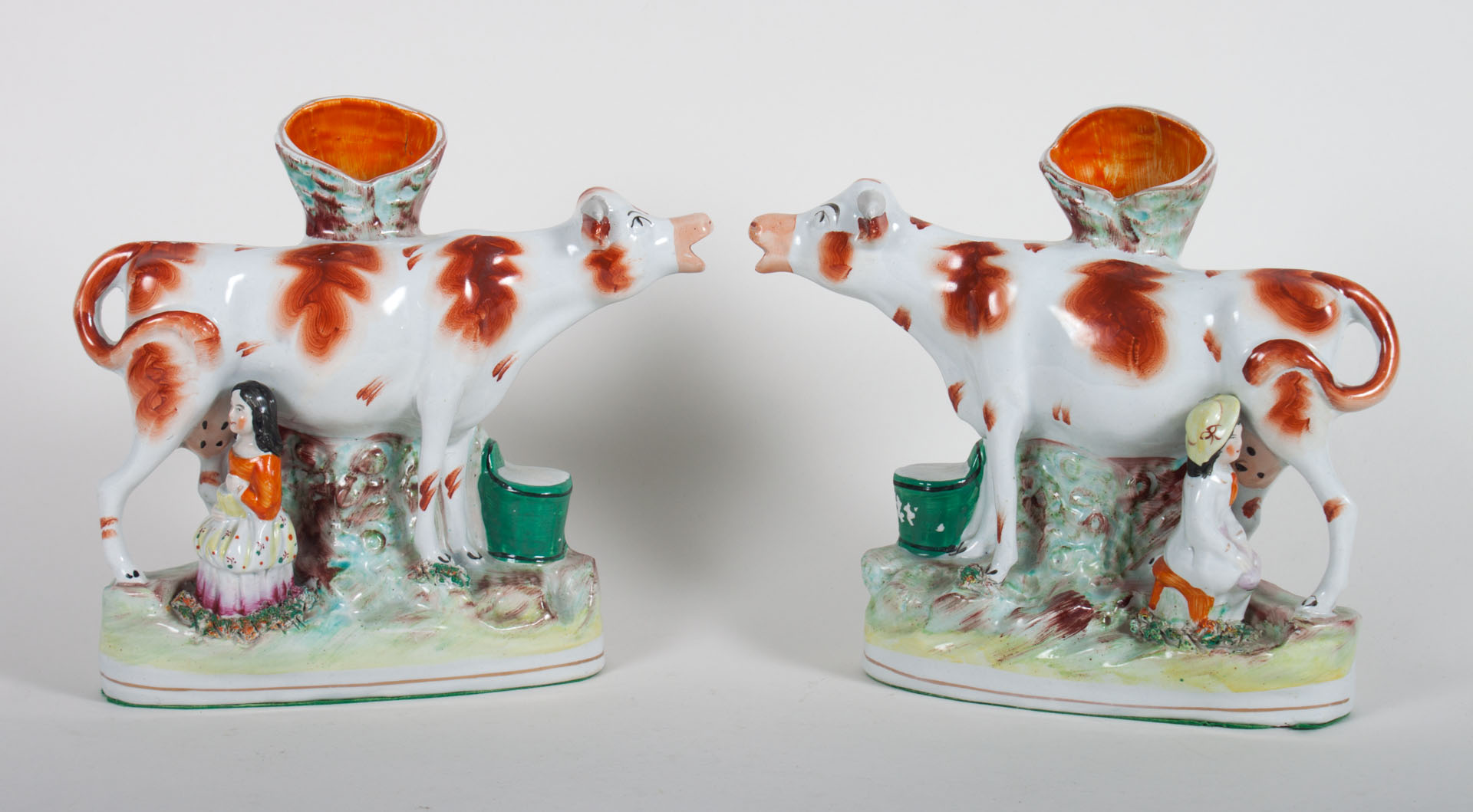 Appraisal: Pair of Staffordshire milkmaid and cow spill vases late th