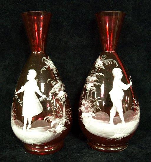 Appraisal: A pair of cranberry glass vases with Mary Gregory style