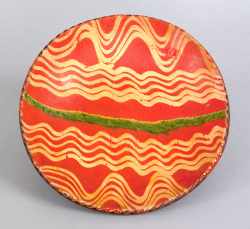 Appraisal: Pennsylvania redware plate th c with yellow and green slip