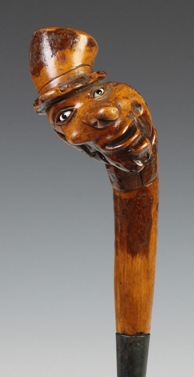 Appraisal: Carved Cane w Carved Face Long Nose Top Hat th