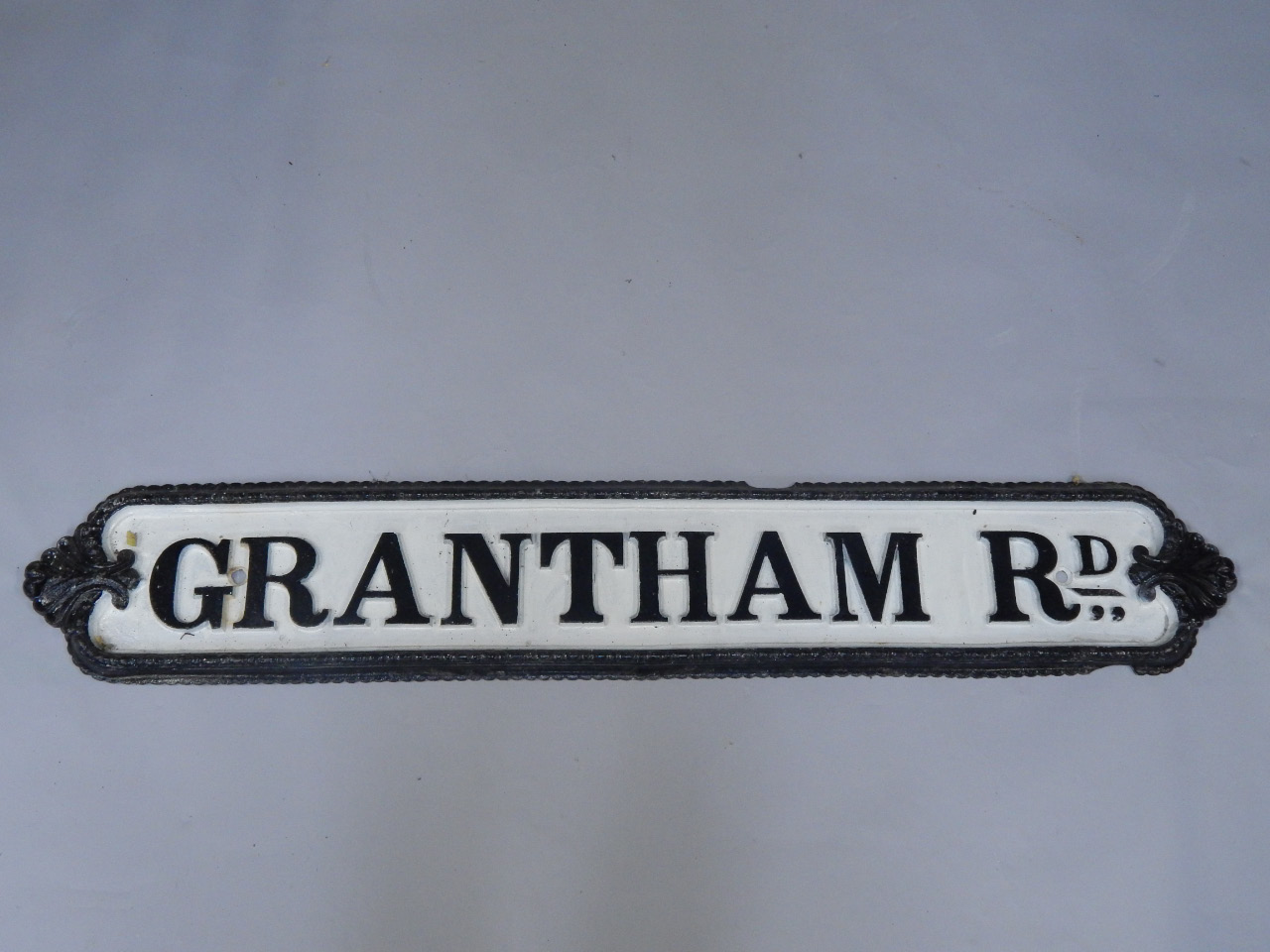 Appraisal: A cast iron Grantham Road sign printed in white cm