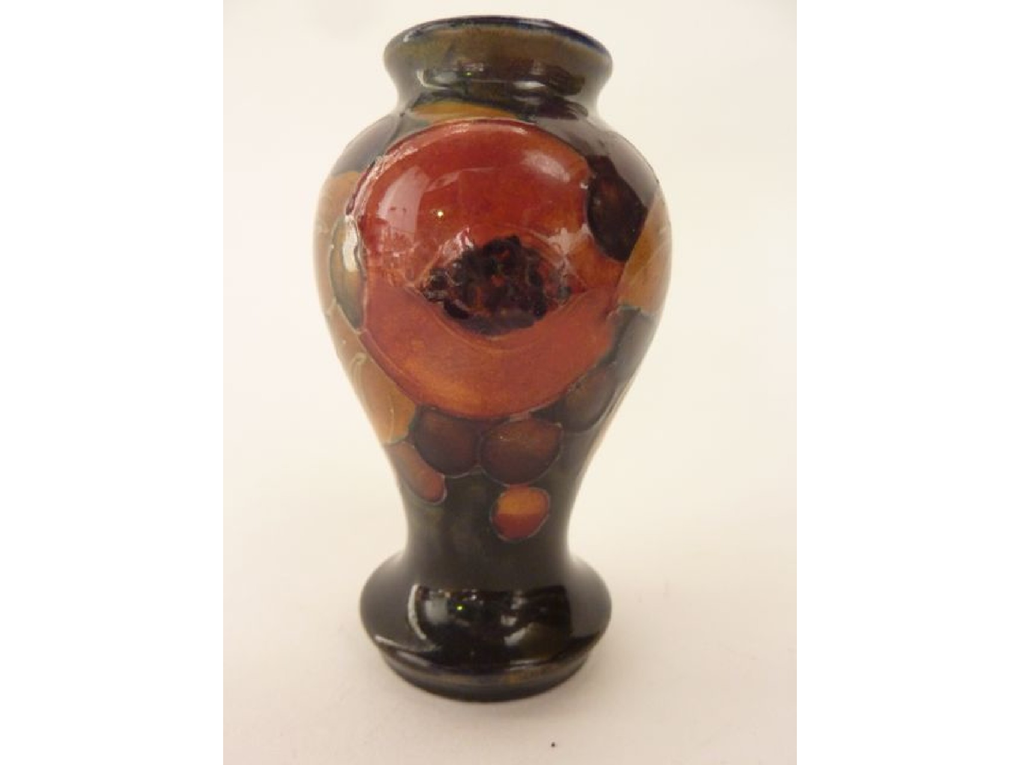 Appraisal: A small Moorcroft vase of baluster shaped form with pomegranate