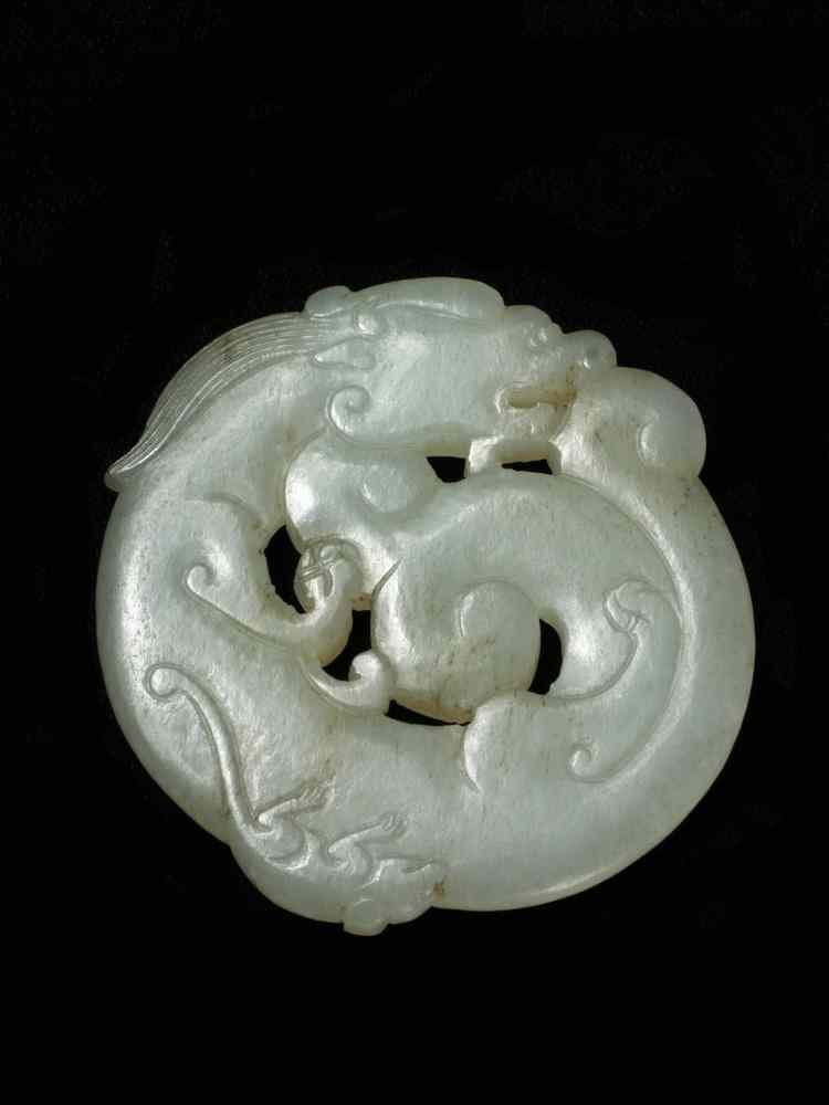 Appraisal: CARVED JADE DISC - Gray white disc form amulet carved