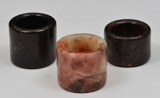 Appraisal: THREE CHINESE AGATE ARCHERS RINGS the first a white and