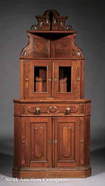 Appraisal: An American Renaissance Walnut Corner Bookcase c molded arched cornice