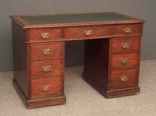 Appraisal: A late Victorian walnut kneehole desk the top inset with