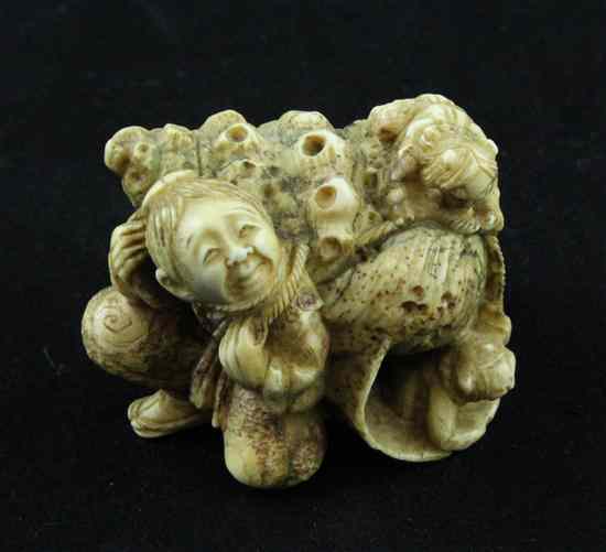 Appraisal: A stained ivory netsuke carved as a man hauling a