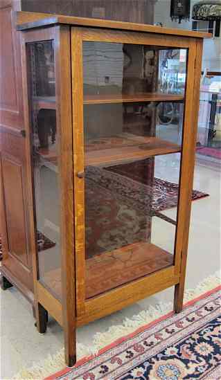 Appraisal: AN OAK DISPLAY CABINET American c having a glass panel