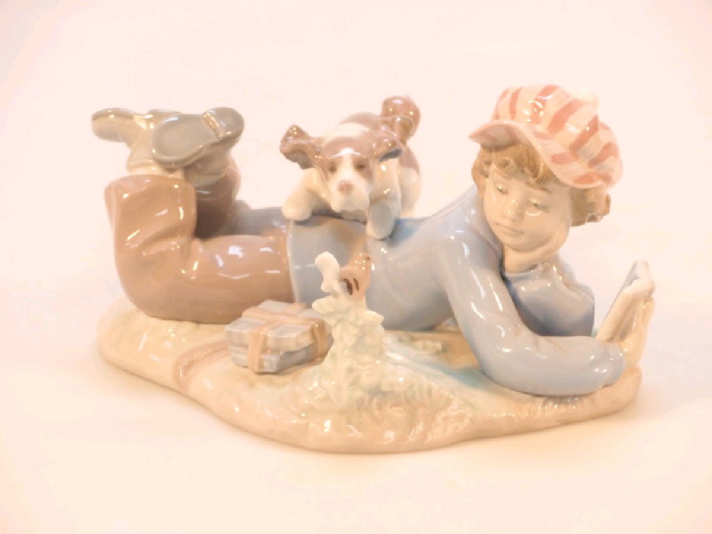 Appraisal: A Lladro figure group of a young boy lying of