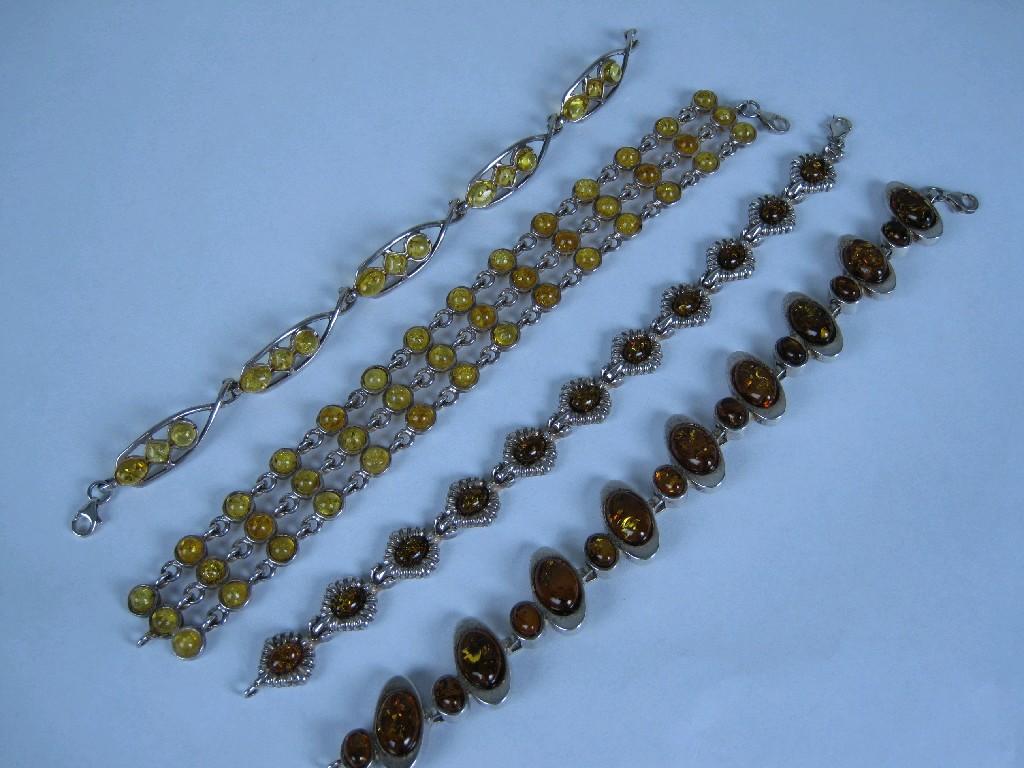 Appraisal: Four various Amber Bracelets set in white metal stamped