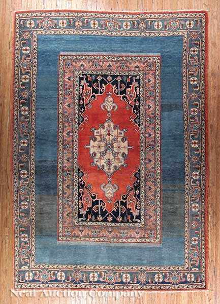 Appraisal: A Persian Serapi Carpet blue and crimson ground central stylized