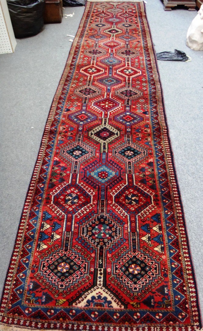 Appraisal: A South Persian runner the madder field with three columns