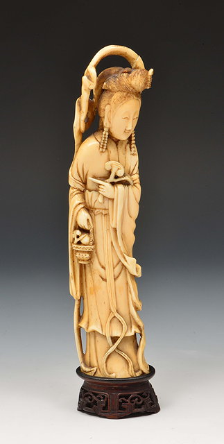 Appraisal: A Chinese carved ivory figure of Ho Sien Ku 'Maiden