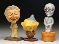 Appraisal: THREE HALLOWEEN NODDERS Consists of composition funny looking man on