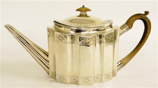 Appraisal: Sterling teapot with floral and scallop pattern decoration wooden handle