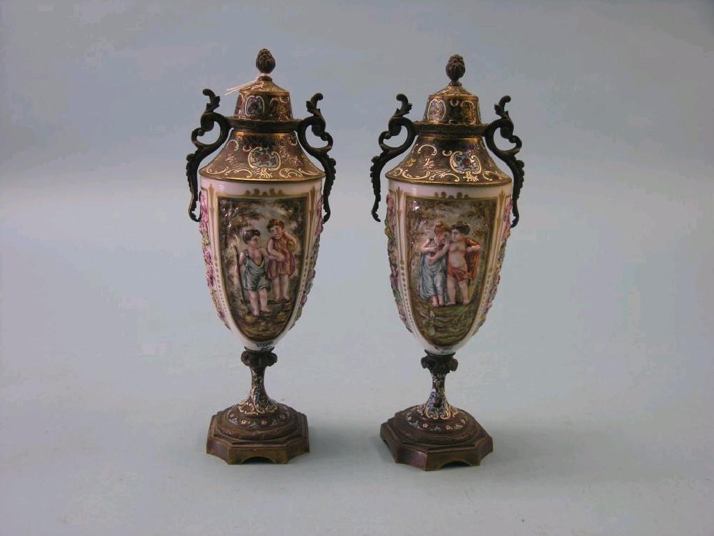 Appraisal: A pair of Naples porcelain and champleve-enamel vases relief moulded