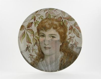 Appraisal: An English pottery wall plaque painted with a Pre-Raphaelite lady