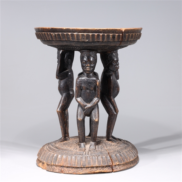 Appraisal: African wooden stool with figures supporting seat detailed designs throughout