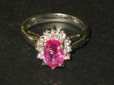 Appraisal: A PINK SAPPHIRE AND DIAMOND CLUSTER RING the oval cut