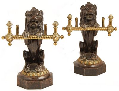 Appraisal: A pair of Victorian patinated iron and brass andirons modelled