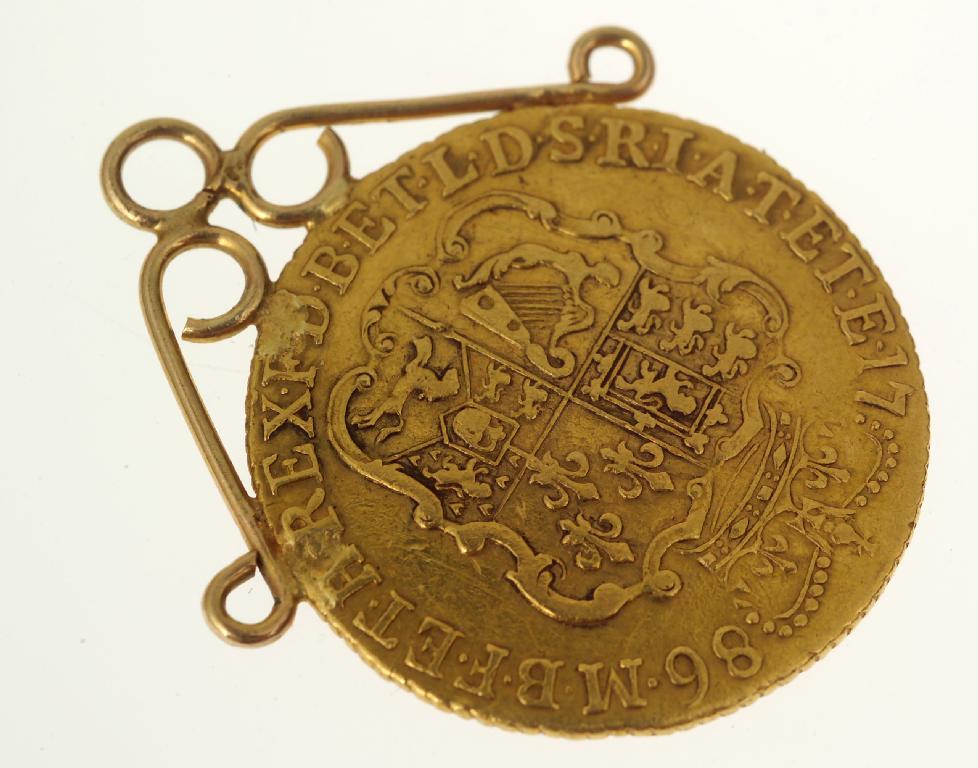 Appraisal: GEORGE III GOLD GUINEA WITH ORNATE CROWNED ARMS with mount