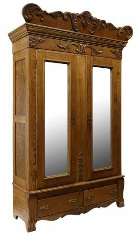 Appraisal: American oak armoire early th c carved crest with scrolling