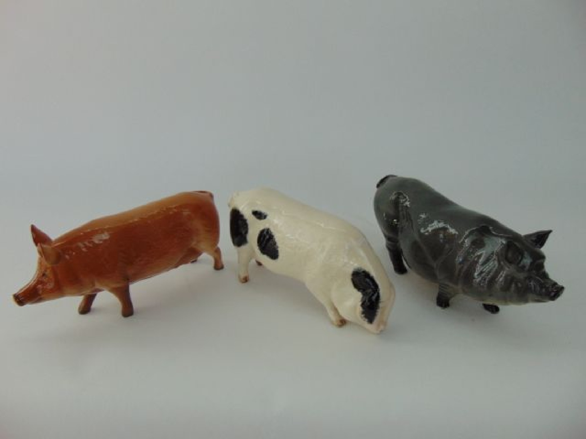 Appraisal: A collection of three Royal Doulton models of pigs including