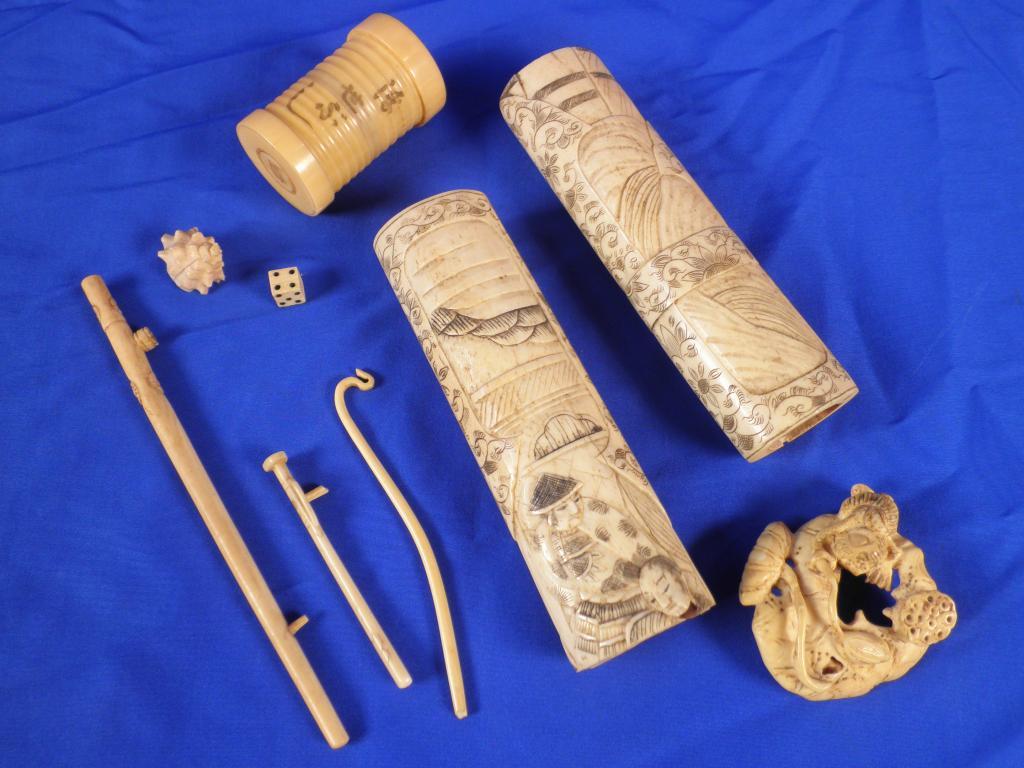 Appraisal: Two Japanese bone sword handles a bone netsuke carved with