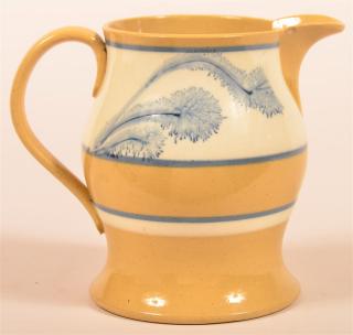 Appraisal: Yellowware Cream Pitcher Seaweed Decoration Yellowware Cream Pitcher with Blue