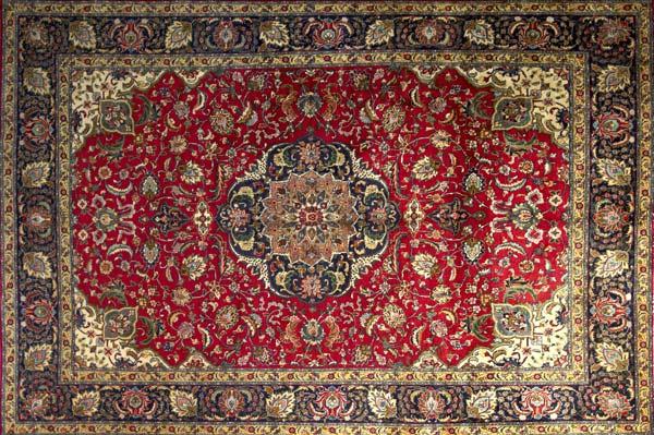 Appraisal: PERSIAN TABRIZ Room-size rug with a large floral multicolored medallion