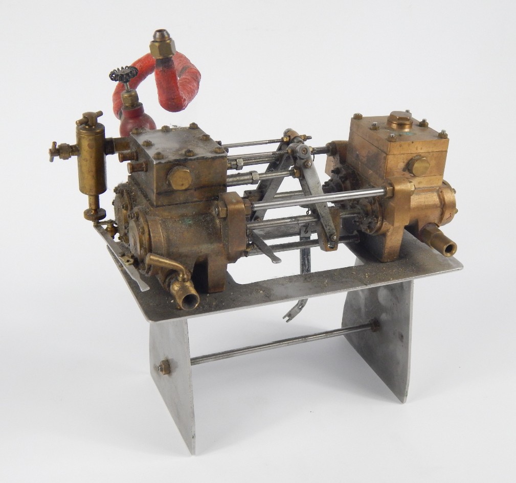 Appraisal: A metal cased stationary horizontal engine with articulated pistons brass