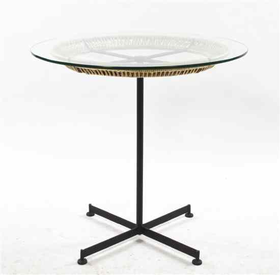 Appraisal: A Rattan Steel and Glass Occasional Table after a design