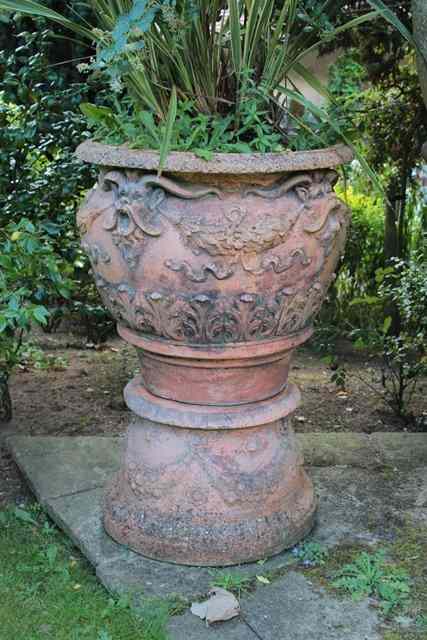 Appraisal: A LARGE PAIR OF TERRACOTTA PLANT POTS each with fawn