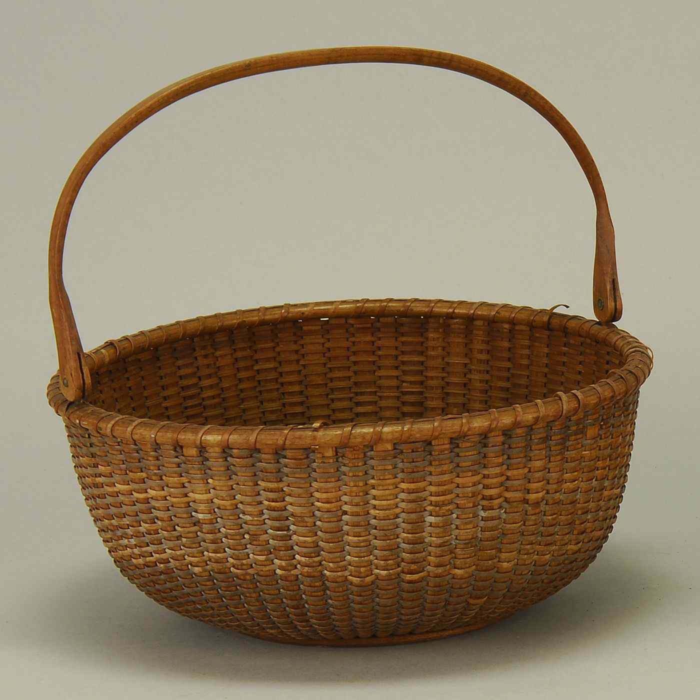 Appraisal: NANTUCKET SWING-HANDLED BASKETAmerican Late th Early th CenturyHeight Diameter ''