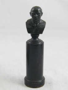 Appraisal: A carved hardstone bust of a gentleman on an ebonised