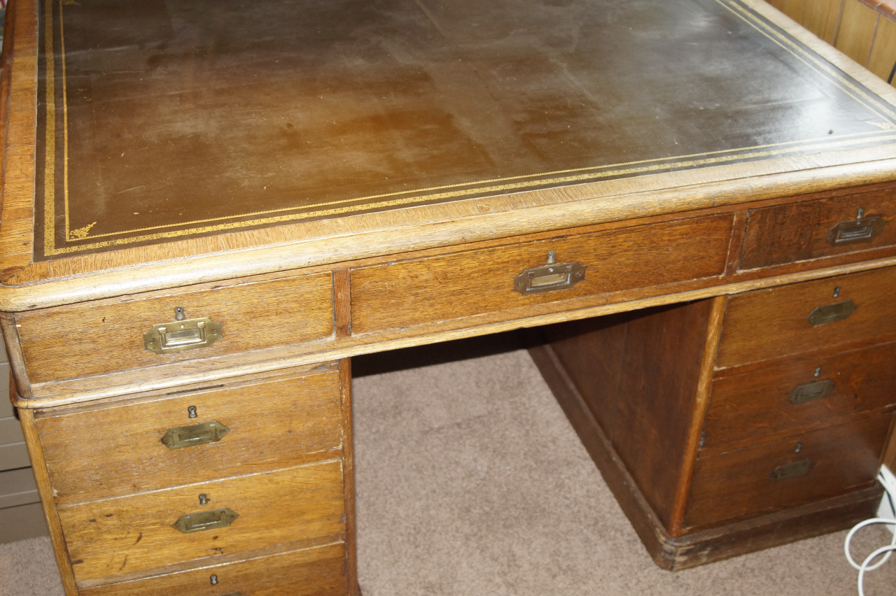 Appraisal: A Victorian oak partners desk with moulded top having leather