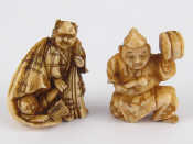 Appraisal: Two ivory netsuke circa one an entertainer with drum the