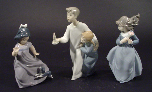 Appraisal: Three hand painted Nao porcelain figures boy and sister with