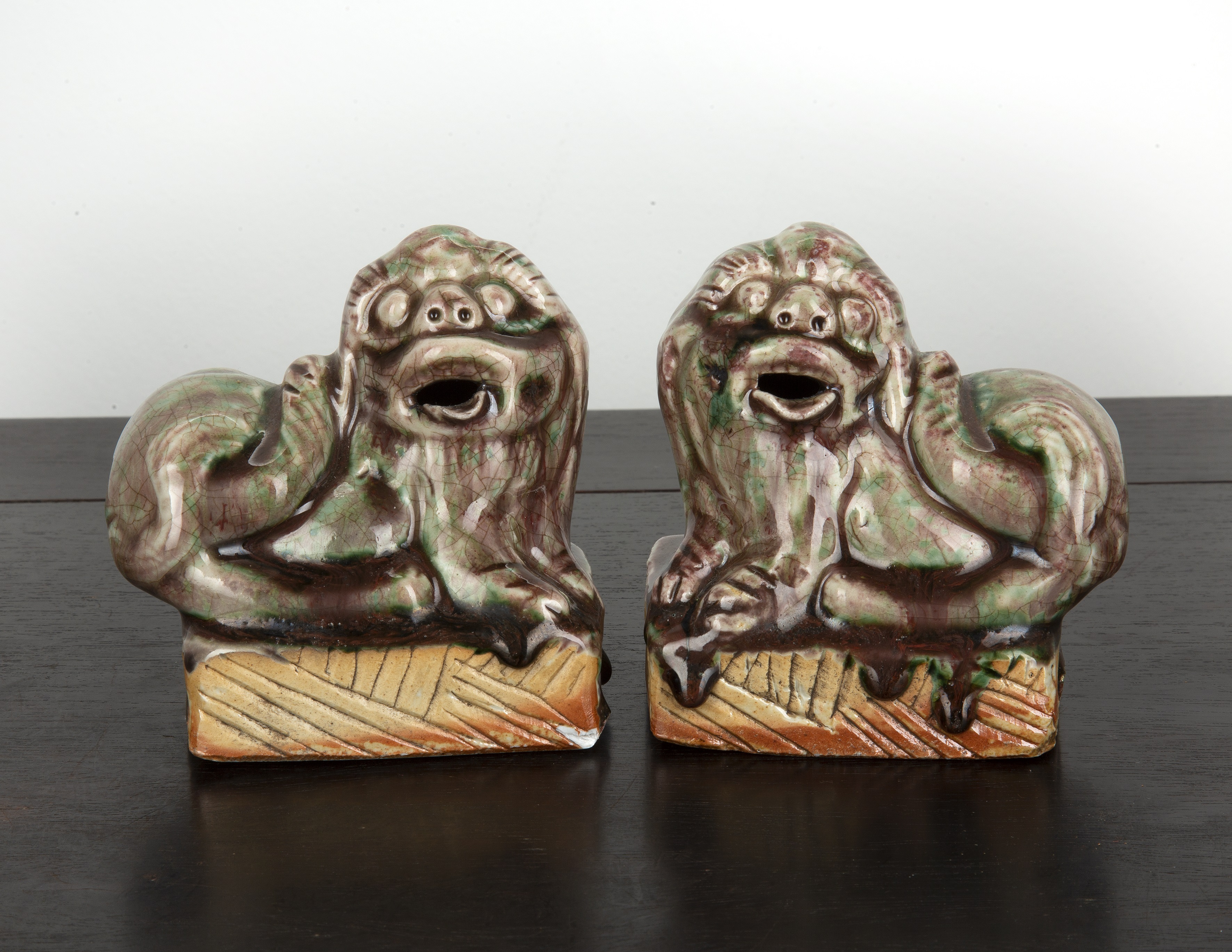 Appraisal: Pair of glazed guardian lionsChinese th Century modelled with their