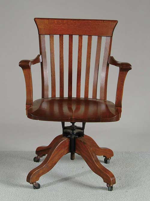 Appraisal: OAK REVOLVING DESK ARMCHAIR Standard form in nice finish with