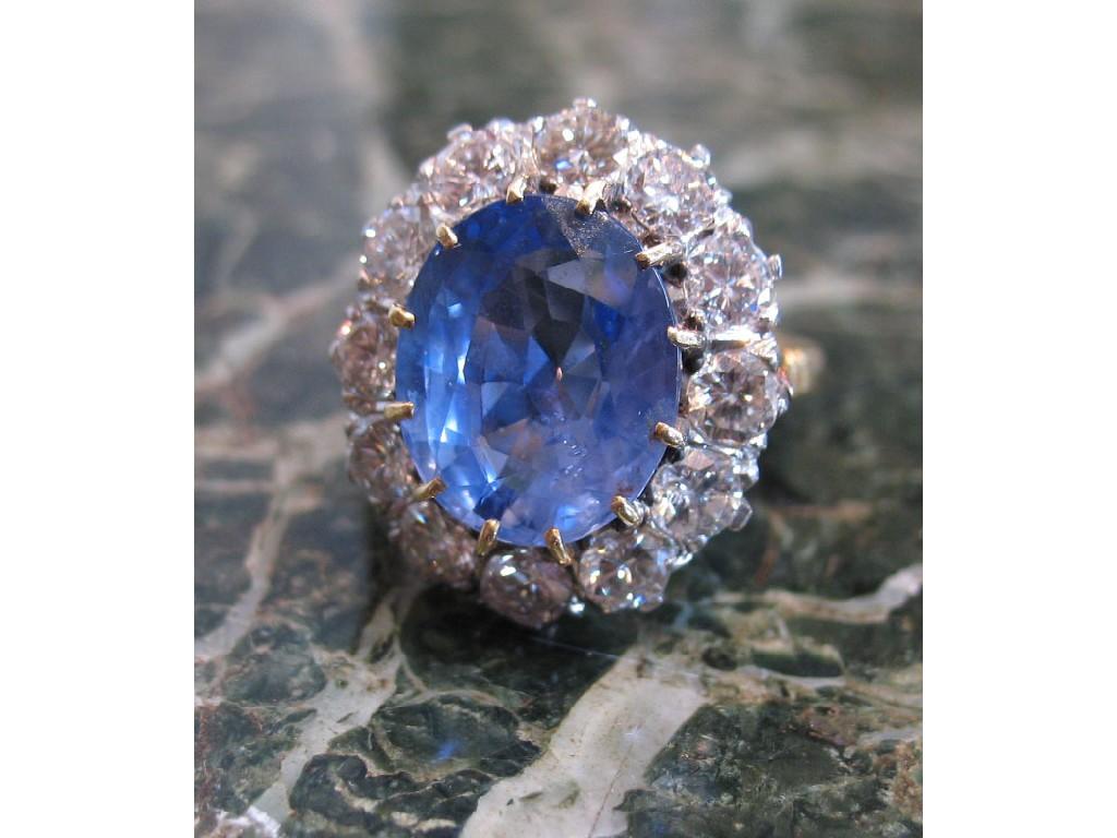 Appraisal: A SAPPHIRE AND DIAMOND CLUSTER RING the central oval cushion-cut