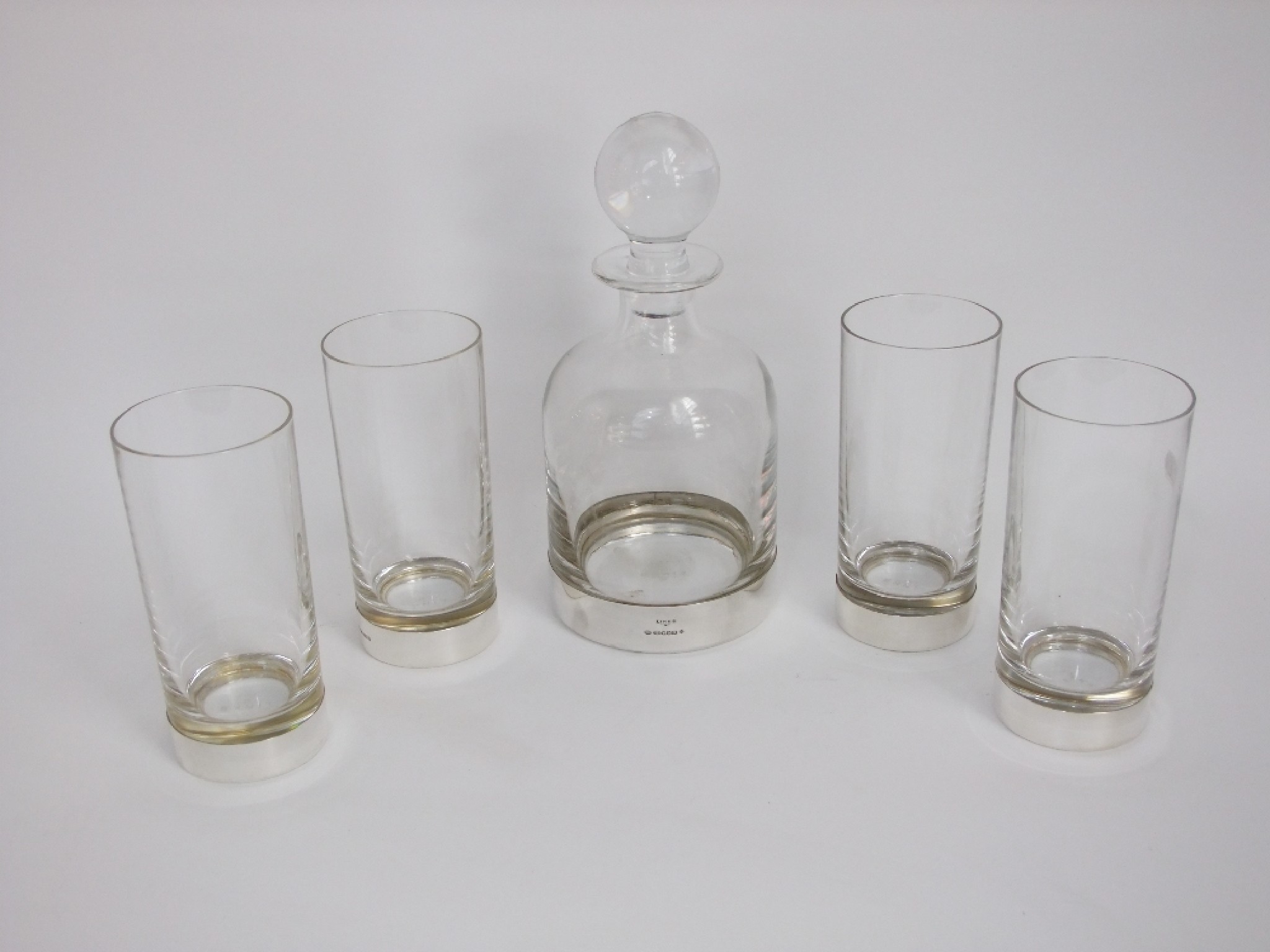 Appraisal: A heavy glass decanter and four large tumblers with silver