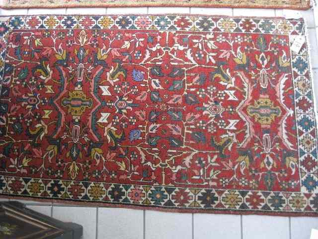 Appraisal: Heriz Persian Handmade Rug stylizedfloral geometric designs on red field